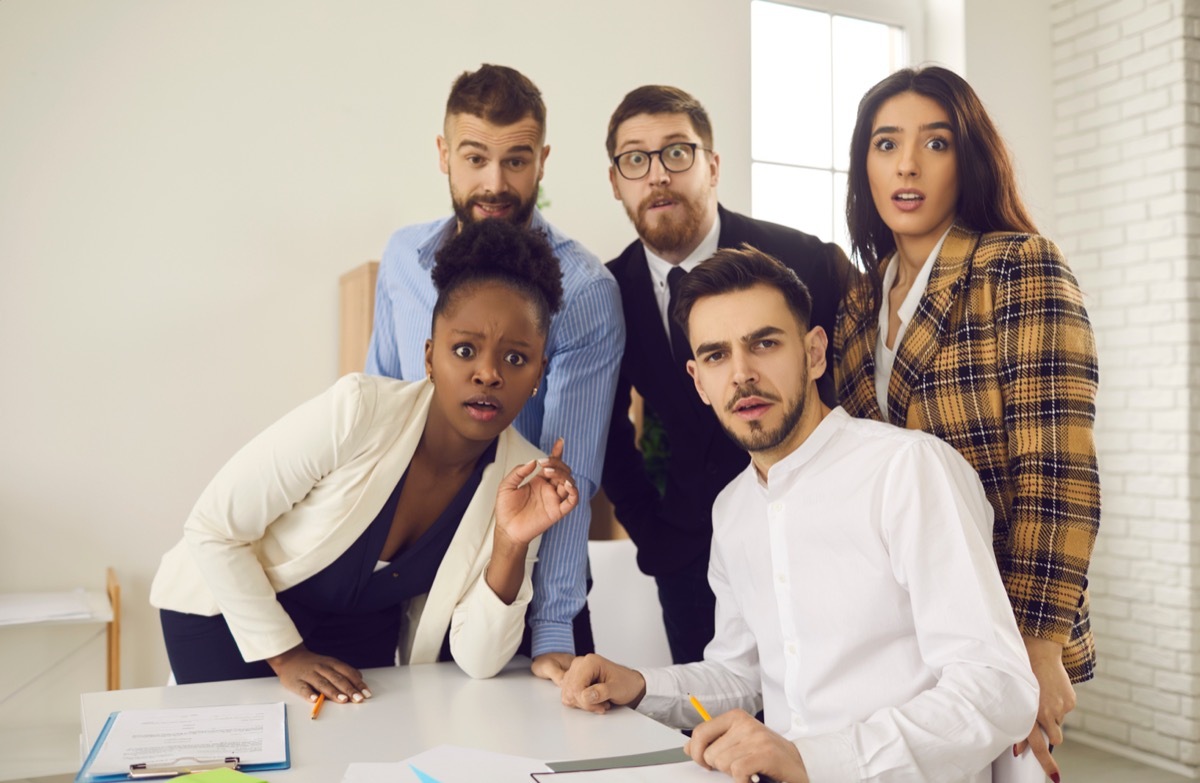 group of co-workers looking surprised when asked to answer a series of weird icebreaker questions