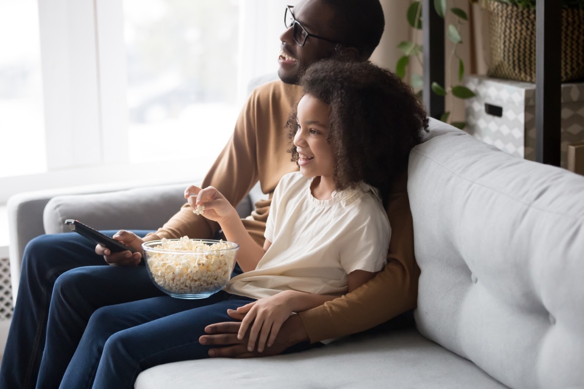 father and daughter watching movie