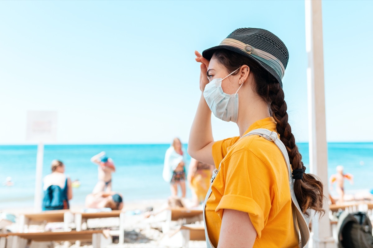 Woman at beach in mask