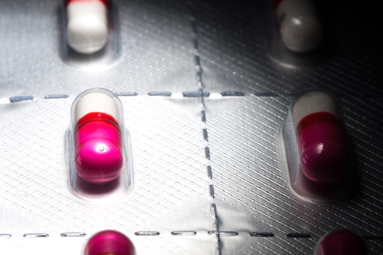 Pink antihistamine capsules in blister pack.