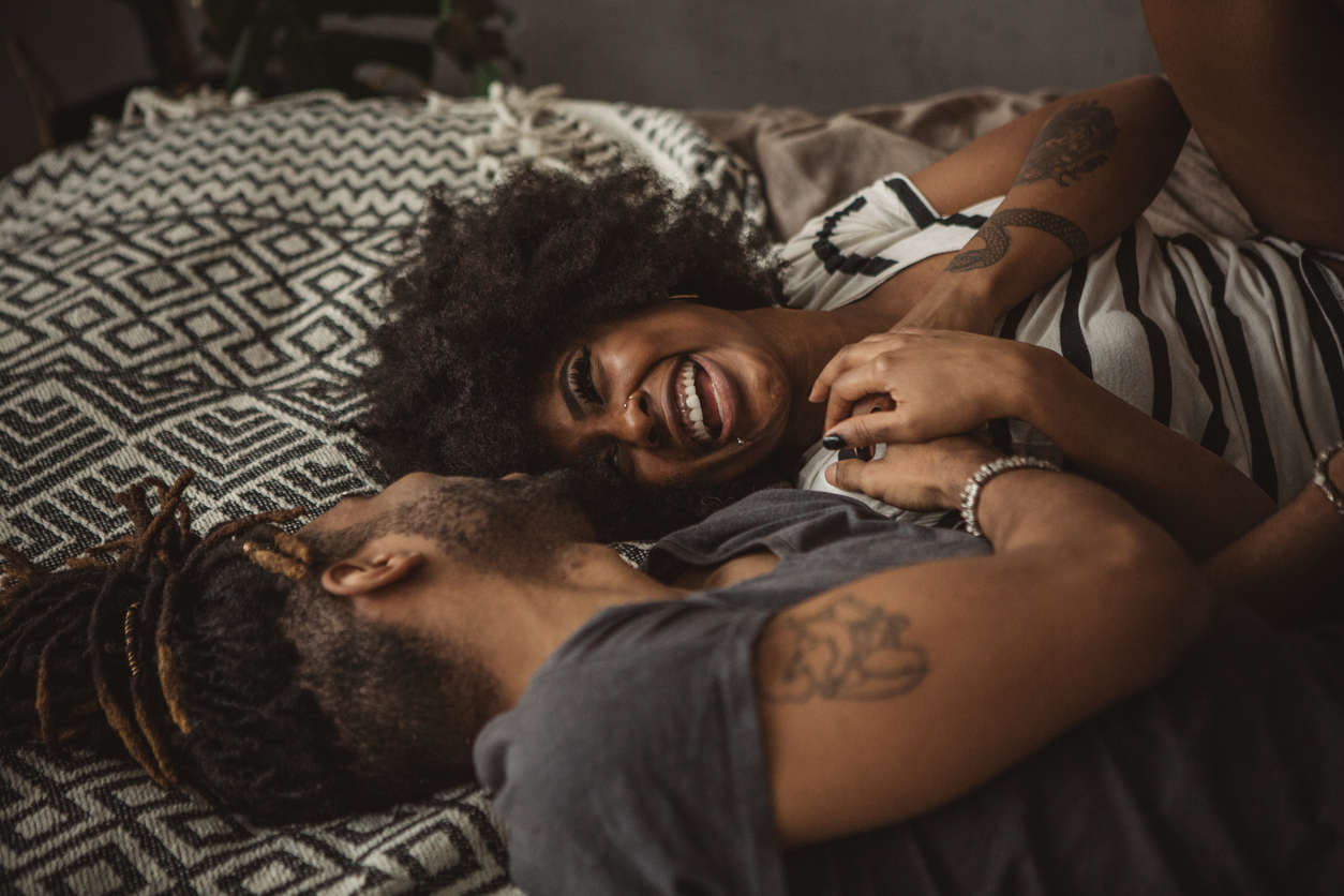 Young couple snuggling in bed 