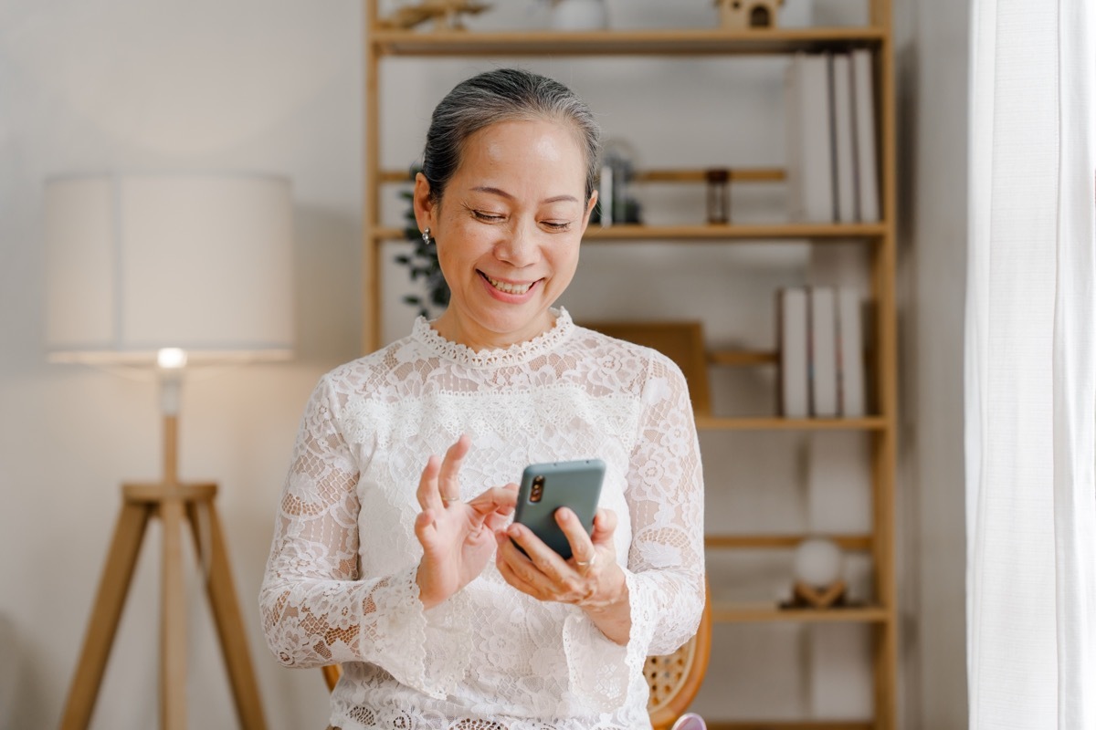 woman smiling while on her phone