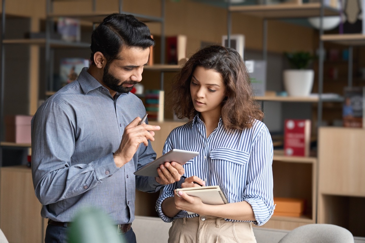 Two People Going Over a List