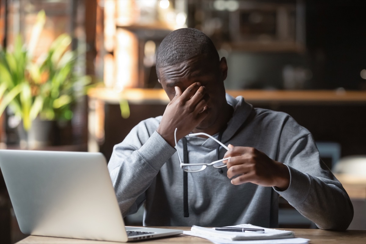 Man experiencing fatigue at desk