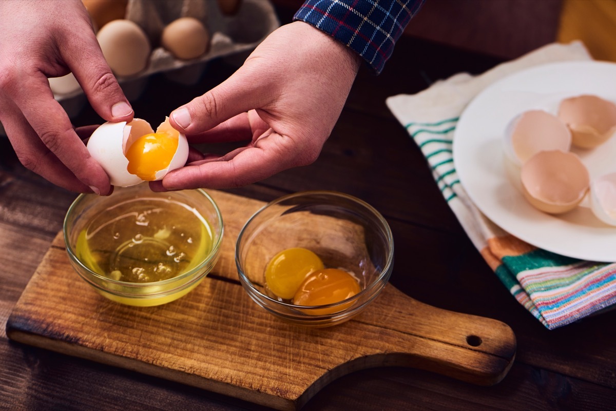 a man separating egg yolks from eggs