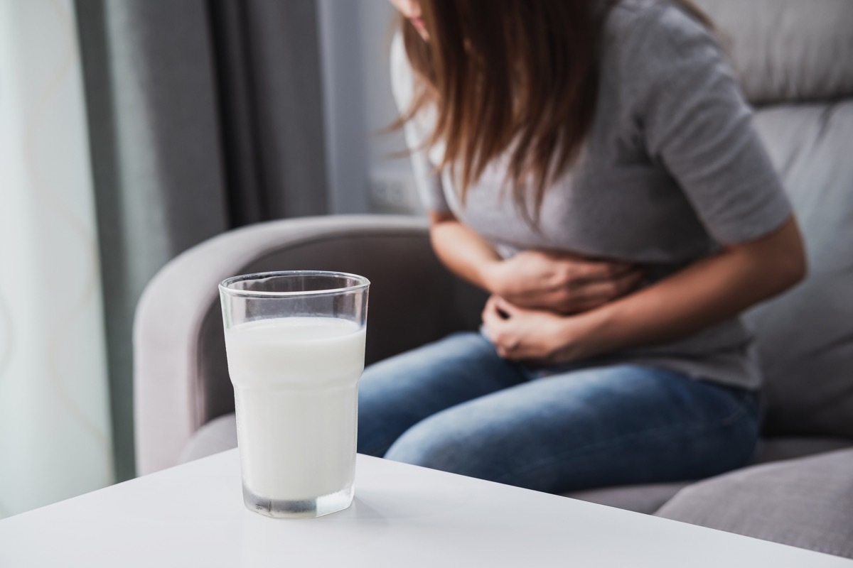 woman sitting in pain, stomach pain