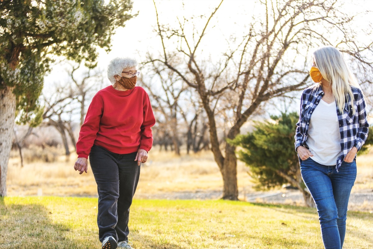 In Western Colorado Mature Adult Female and elderly senior adult female Wearing Face Masks and Demonstrating Social Distancing Due to Infectious Virus Outbreak Pandemic Series (Shot with Canon 5DS 50.6mp photos professionally retouched - Lightroom / Photoshop - original size 5792 x 8688 downsampled as needed for clarity and select focus used for dramatic effect)