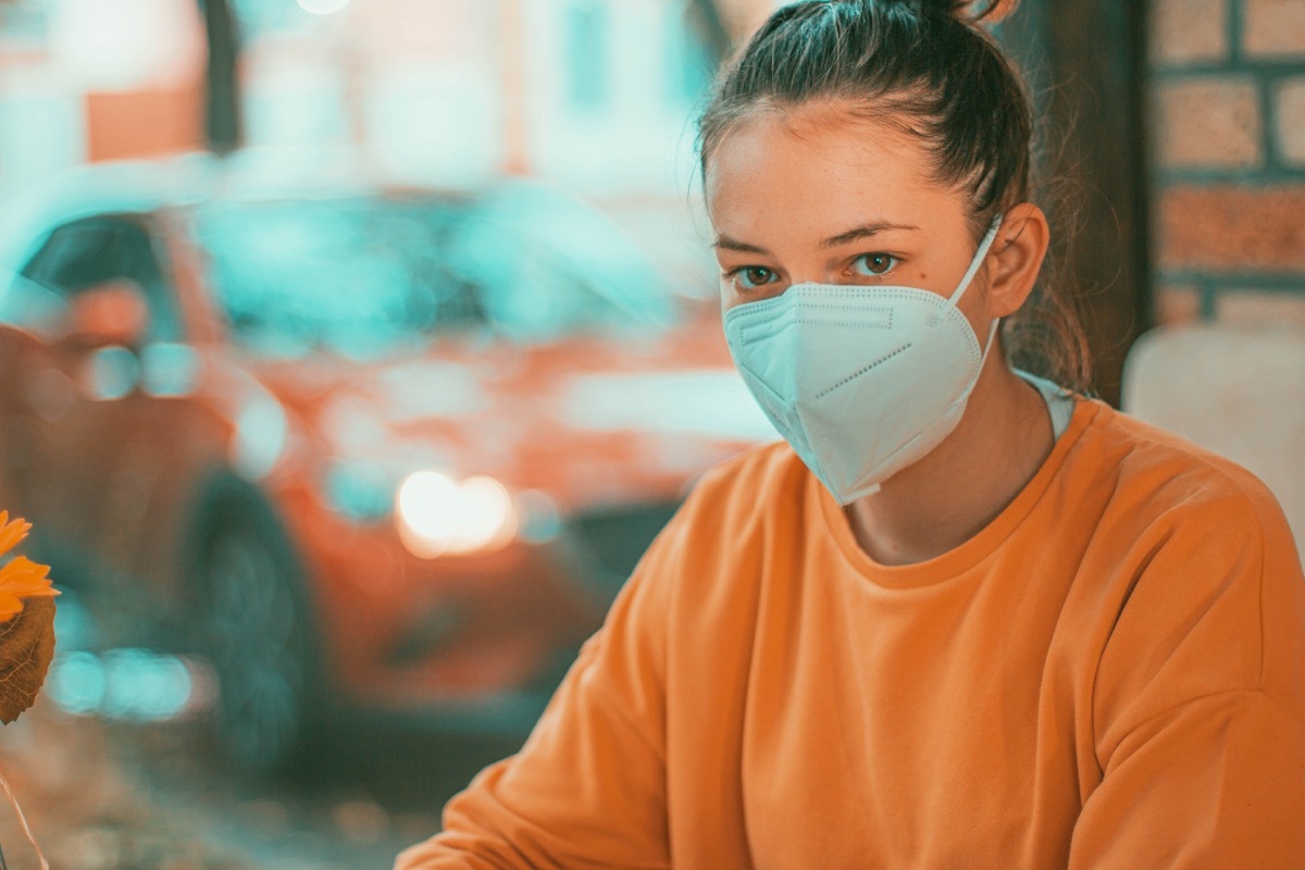 Woman in a restaurant with face protection mask kn95.