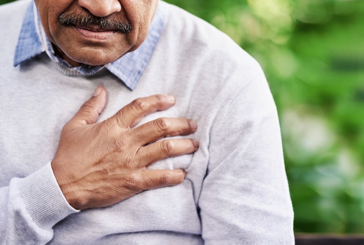 Man holding his chest because of heart pain