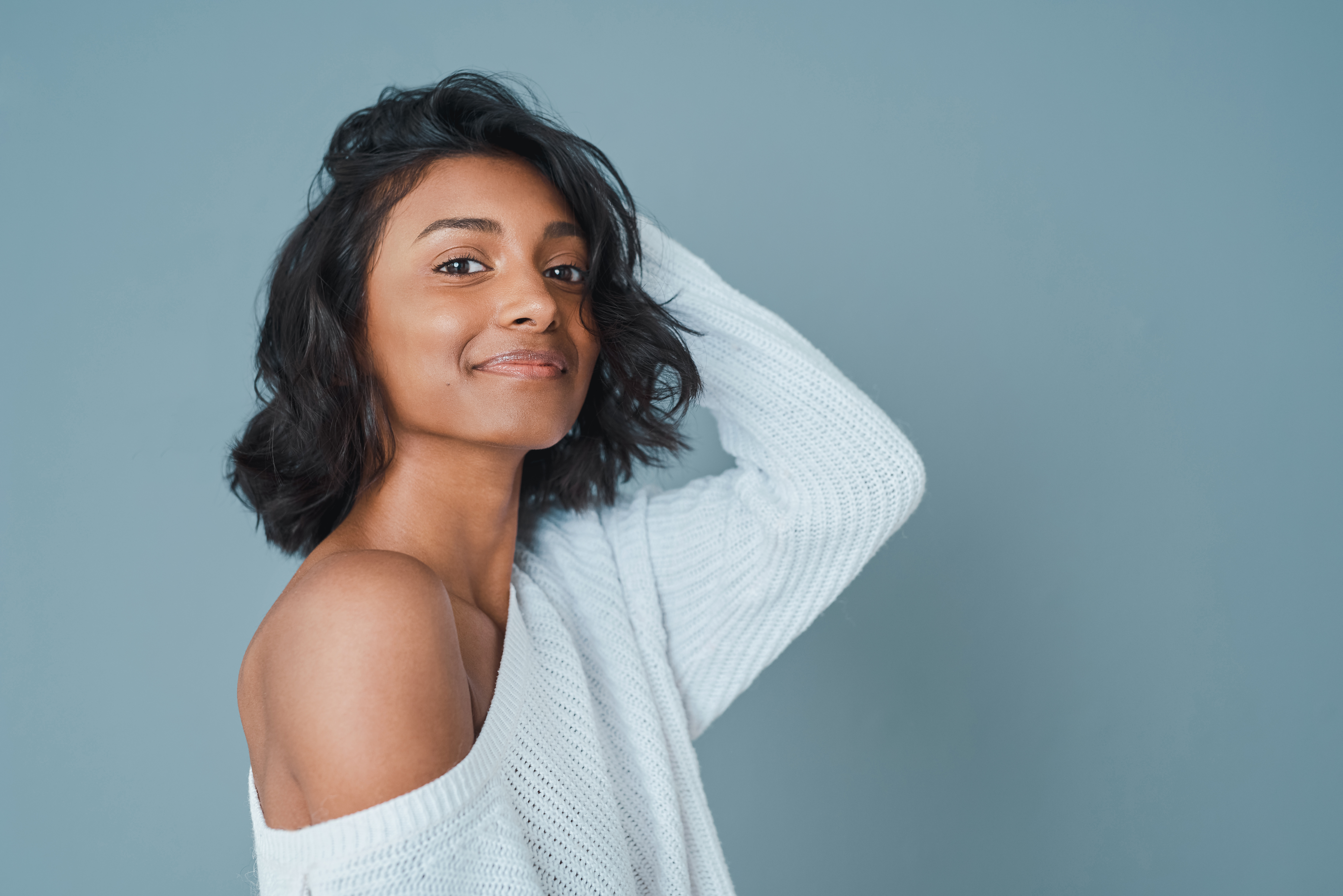 Cropped shot of a beautiful young woman posing against a teal background