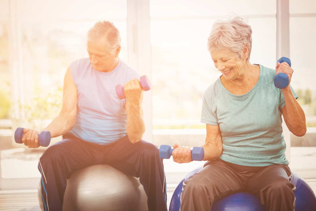 elderly couple happily exercising