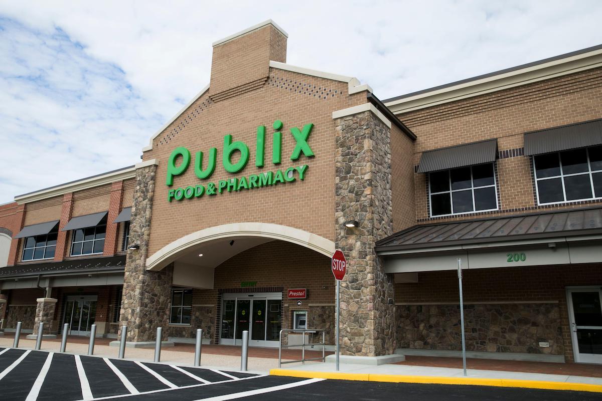 A logo sign outside of a Publix Super Markets retail grocery store location in Midlothian, Virginia 