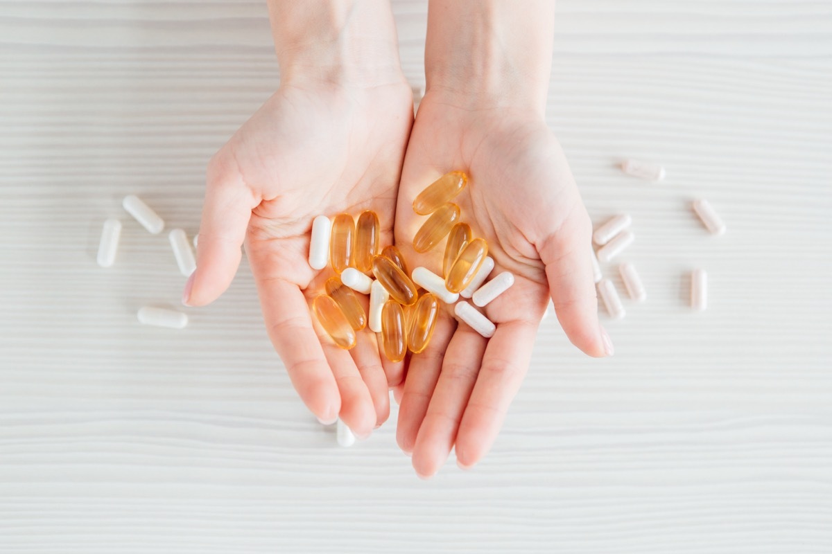 hand holding supplements in hand, calcium and vitamin d