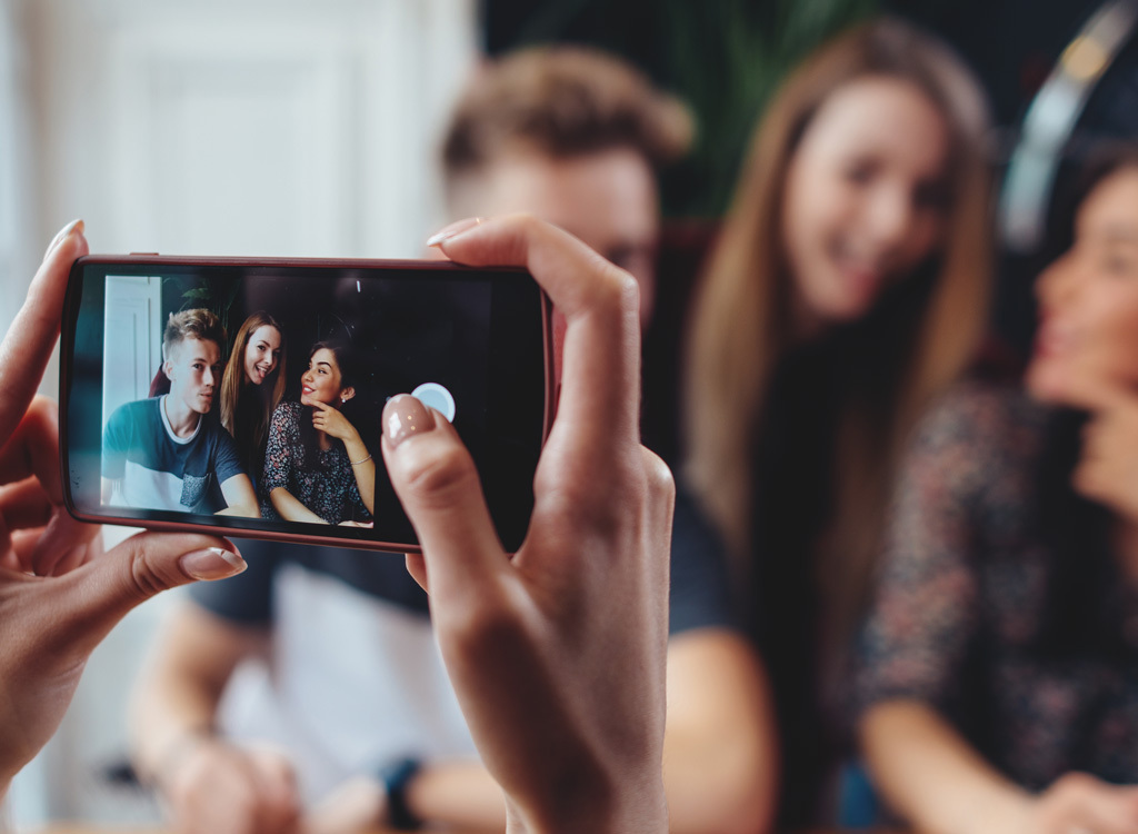 Woman taking group photo phone