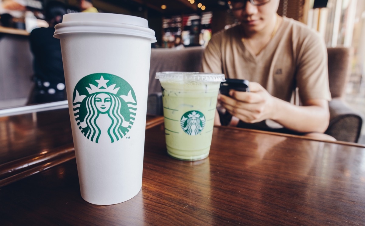 A Venti size of Starbucks coffee with Grande size of Ice green tea latte in Starbucks coffee shop.