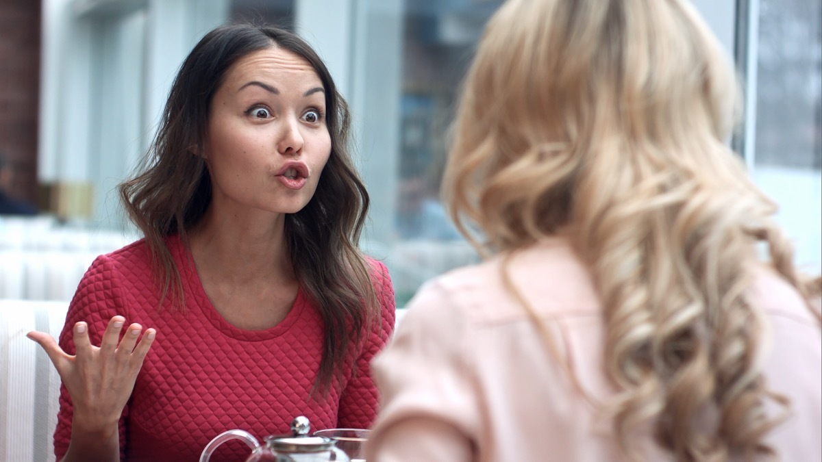 Two women argue in a cafe