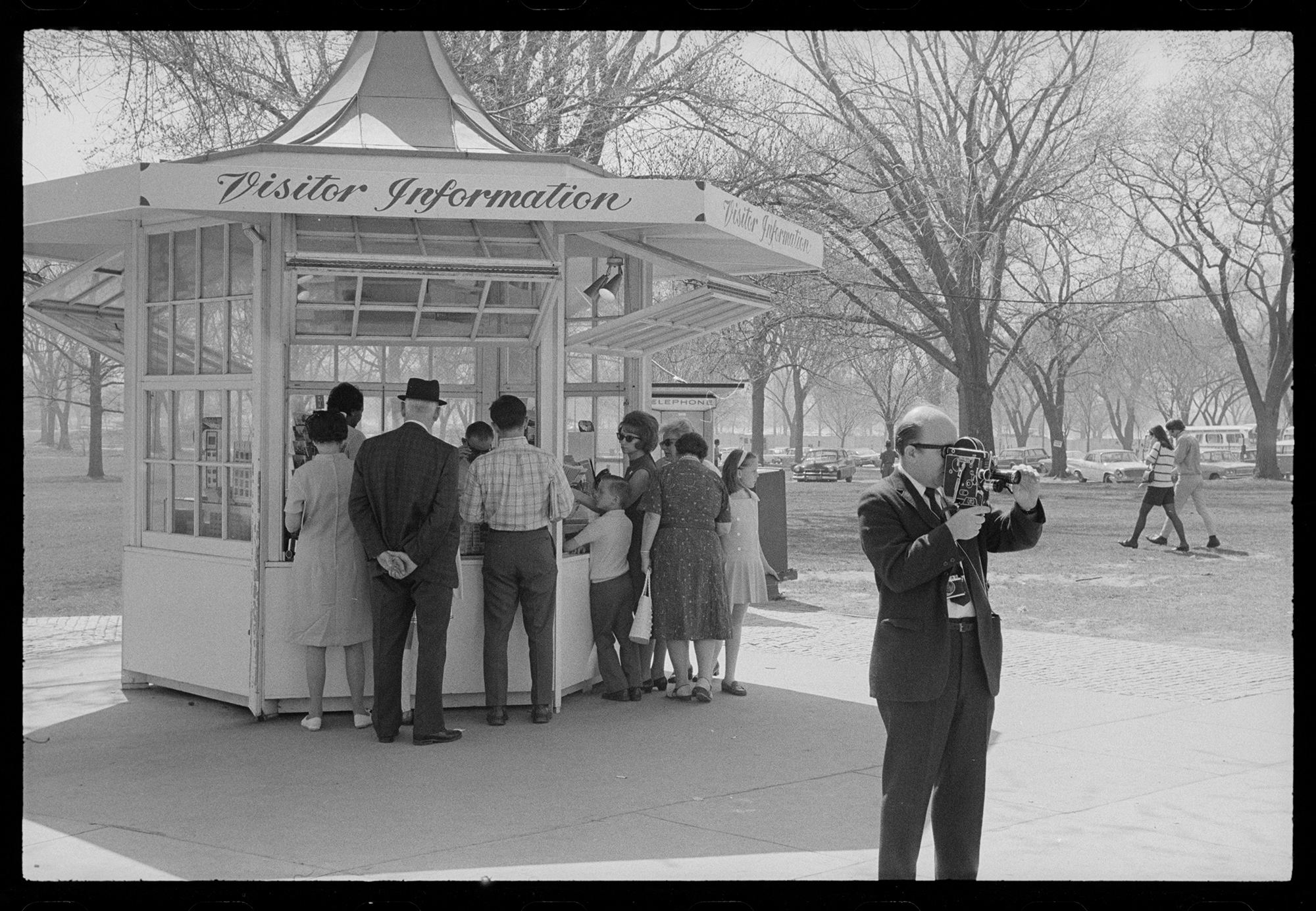 a group of people approach an information booth