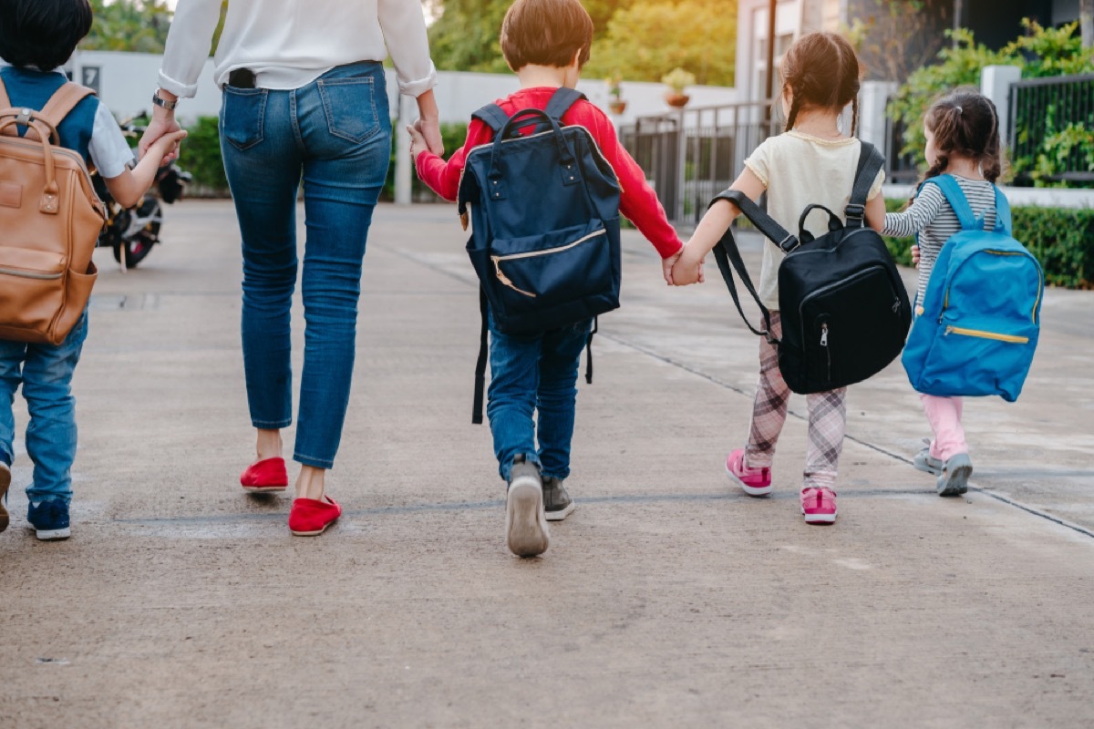 woman walking children to school, stay at home mom