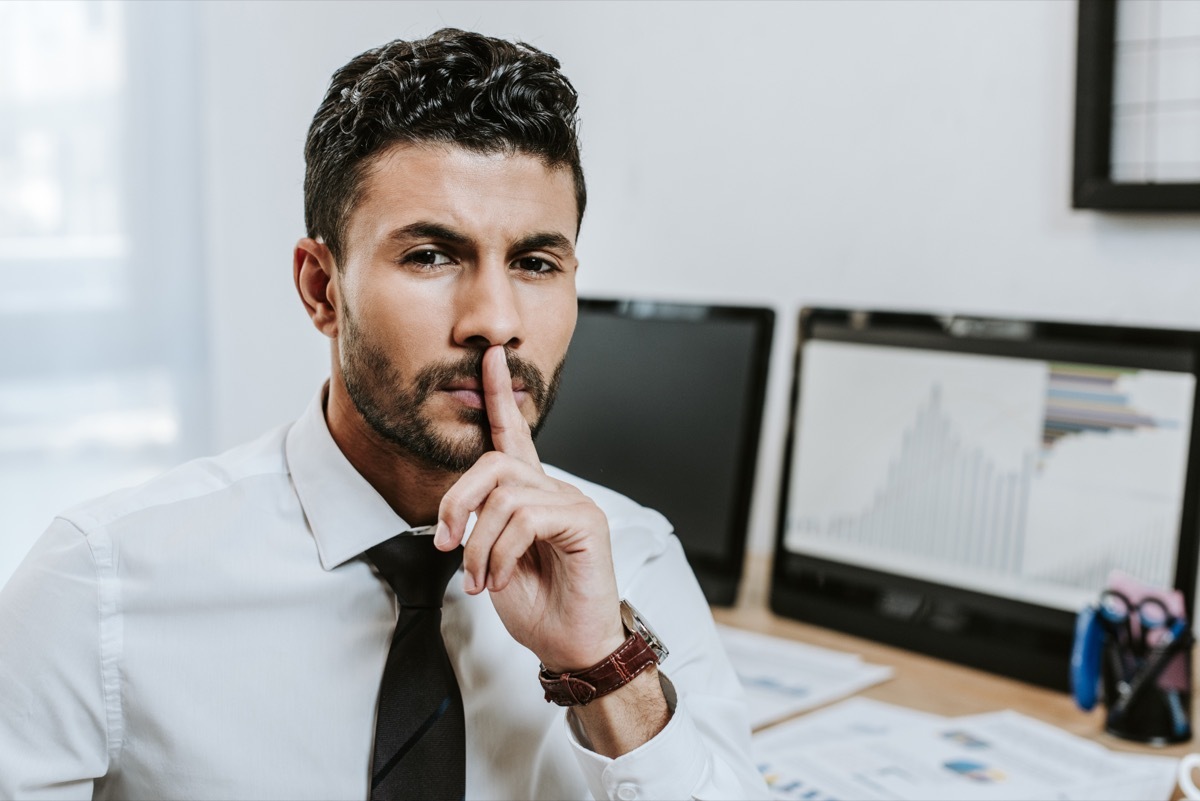 Secretive businessman in a suit,