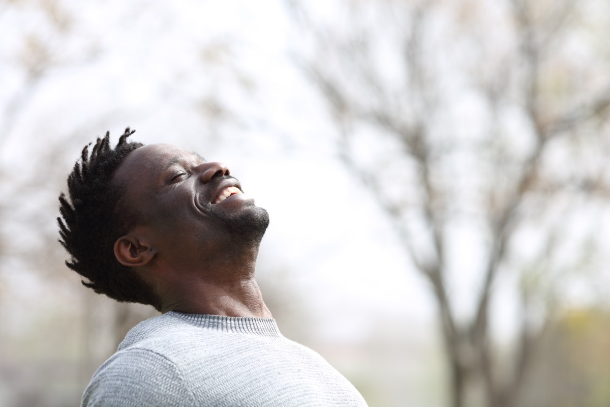 Man smiling while outside in nature. 