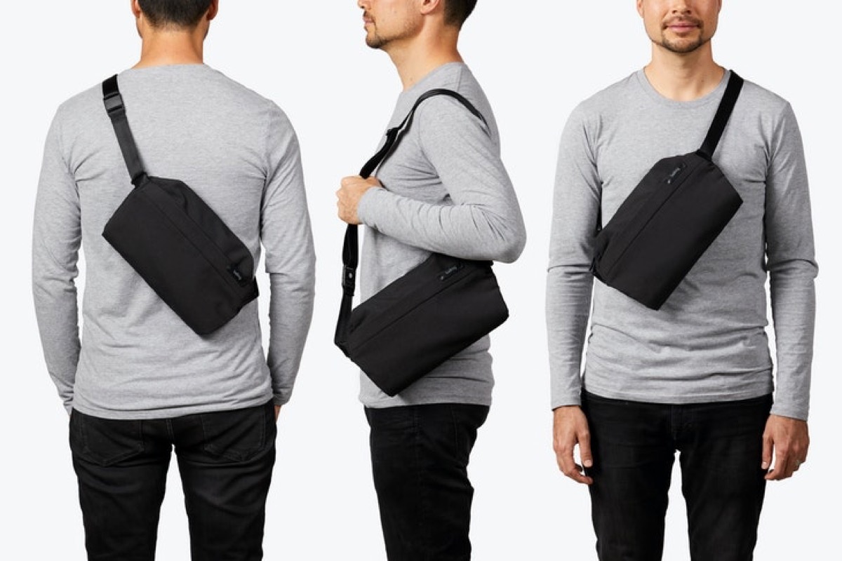 white guy in gray shirt with black cross body bag