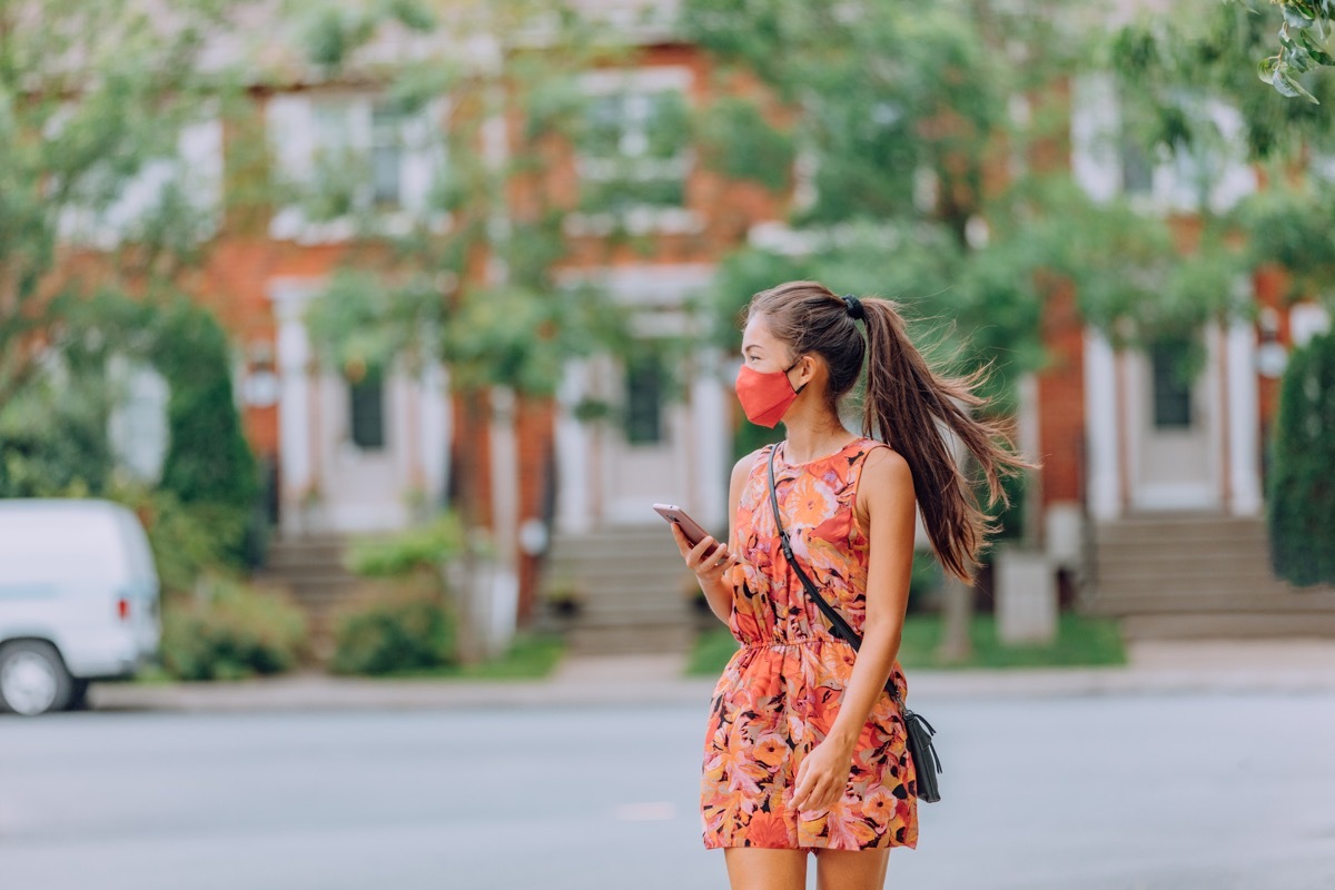 Girl wearing mask outside in summer heat