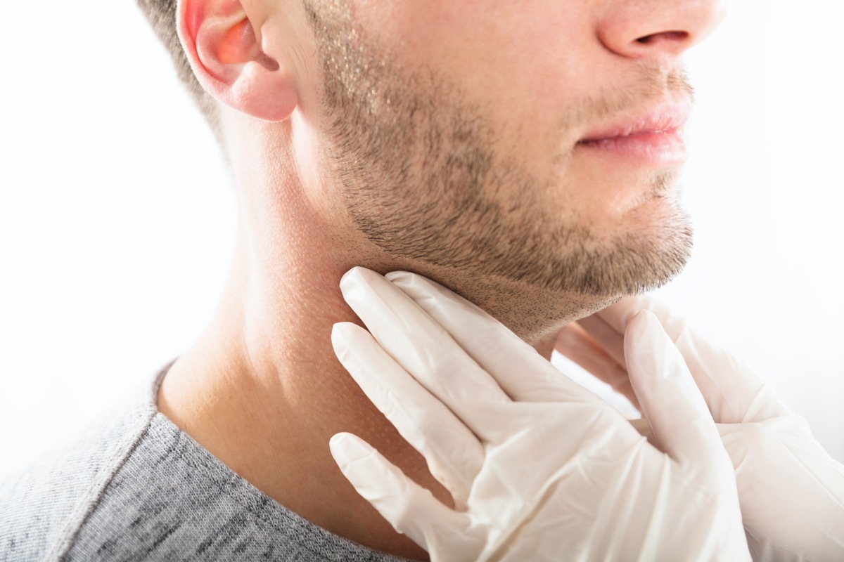 Doctor Performing Physical Exam Palpation Of The Thyroid Gland