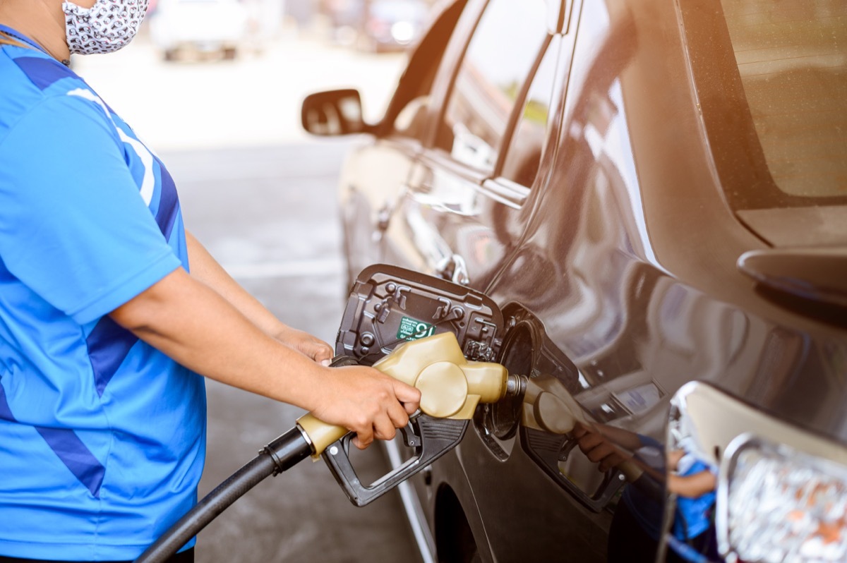 closeup of someone pumping gas at gas station