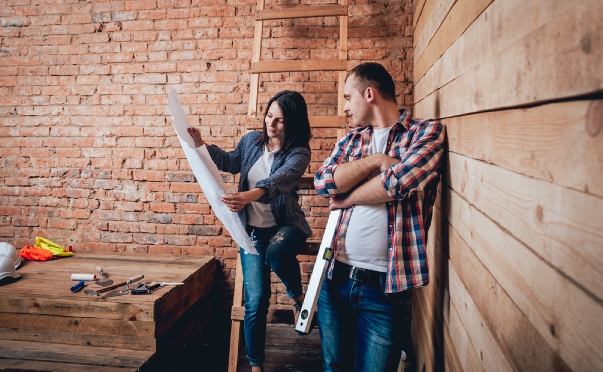 couple looking at blueprints, worst home renovations