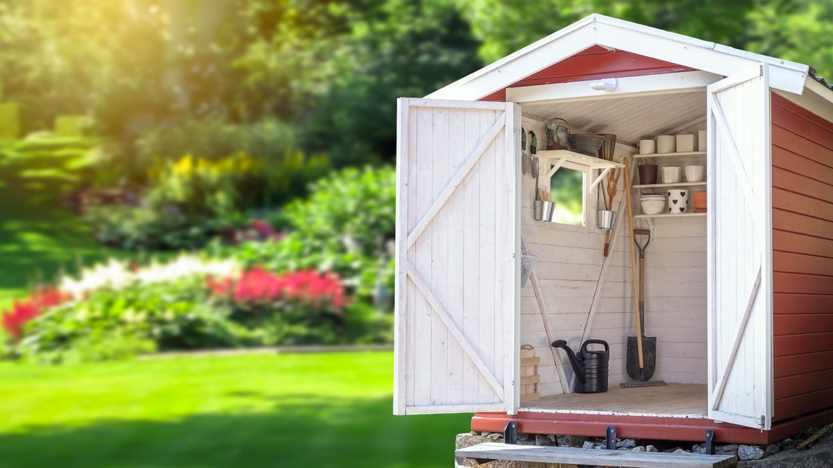 Open Gardening Shed with landscaped yard in background