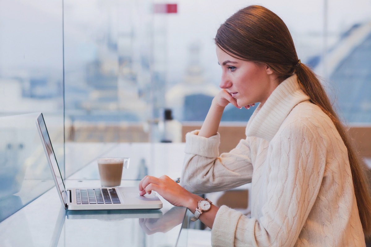 Young woman on her laptop in a cafe