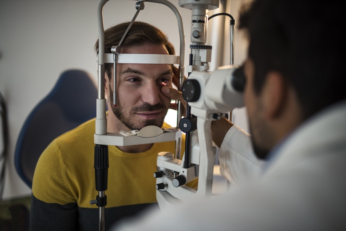 Young men having an eye exam at ophthalmologist's office.