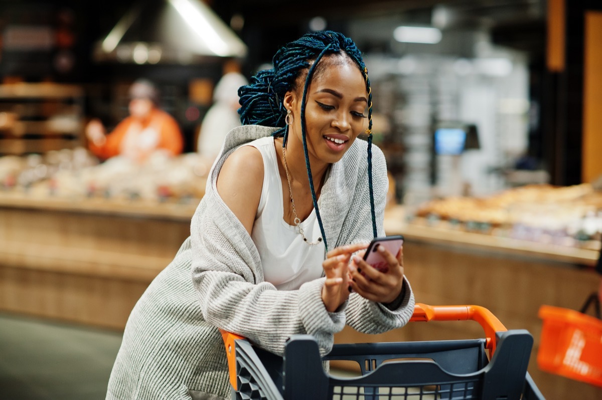 Woman looking at her phone while shopping