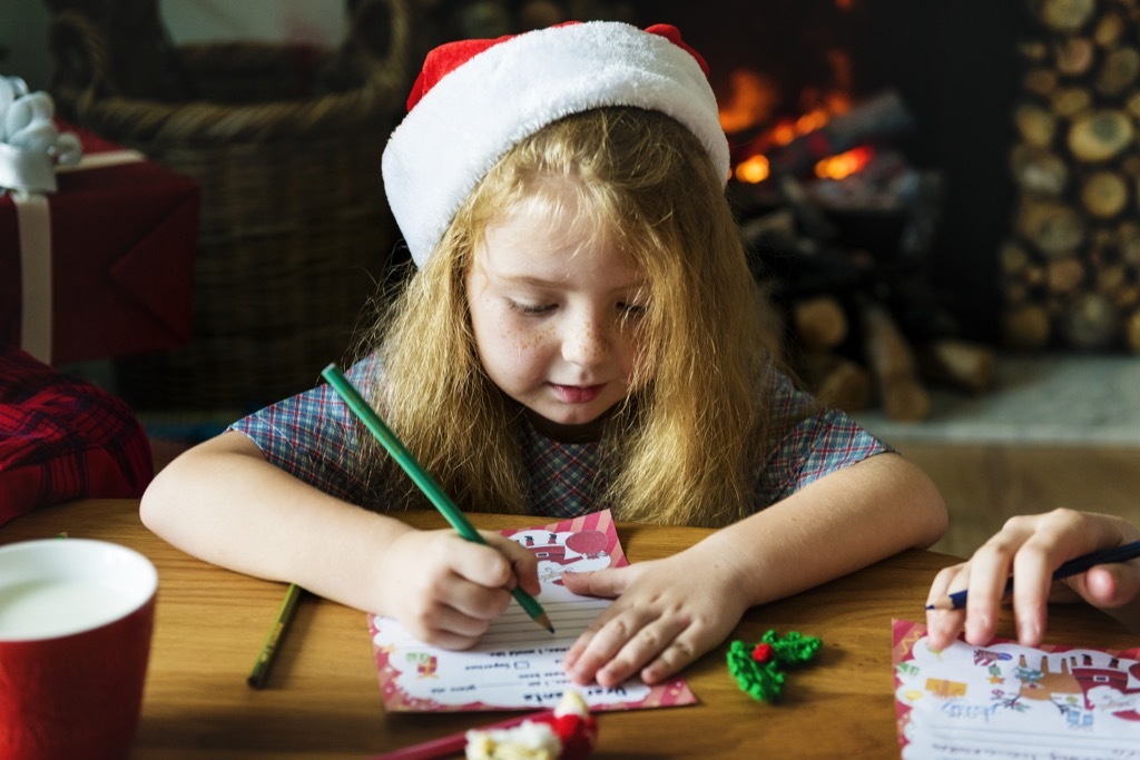 Little girl writing a letter to Santa