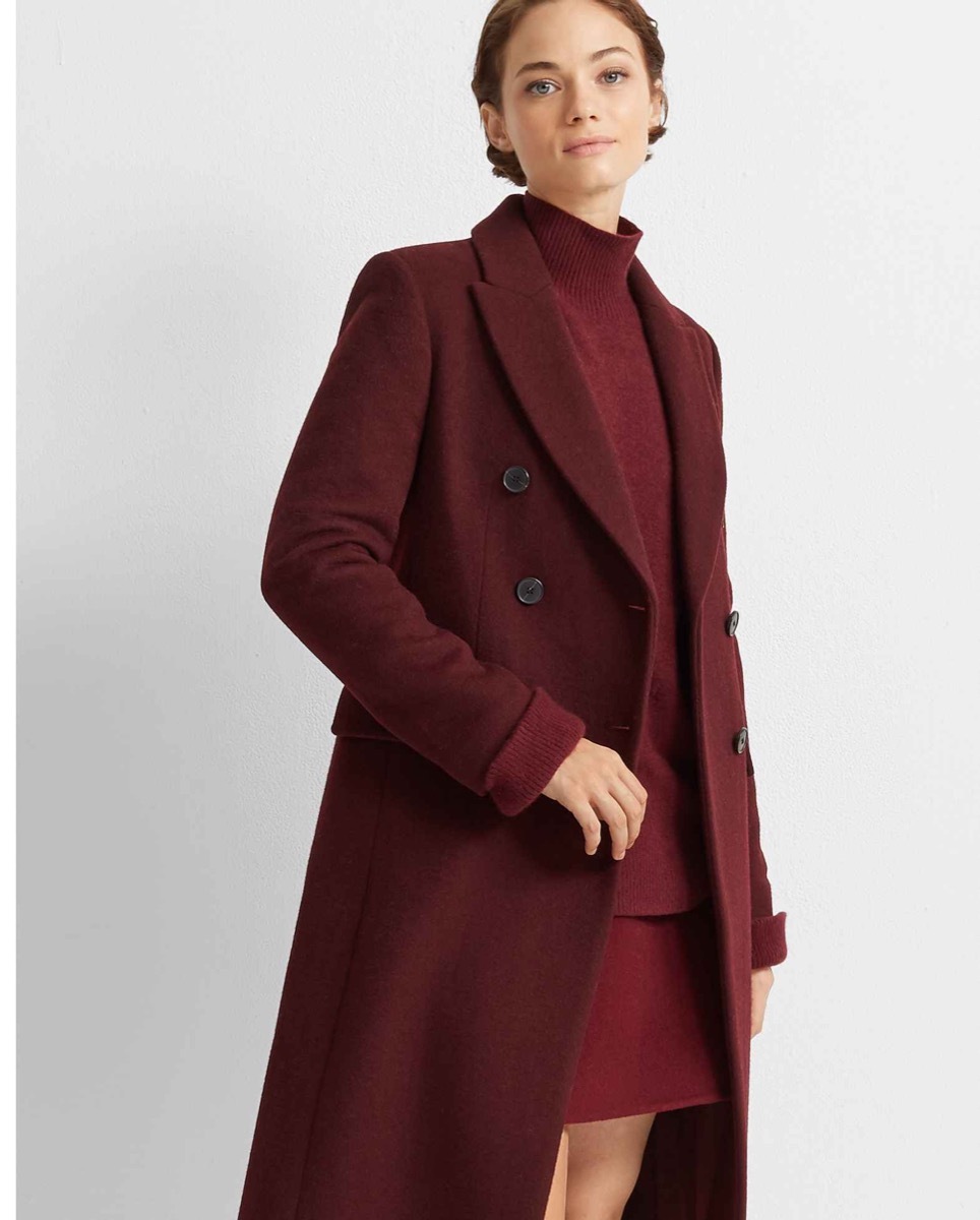 Woman wearing long burgundy coat