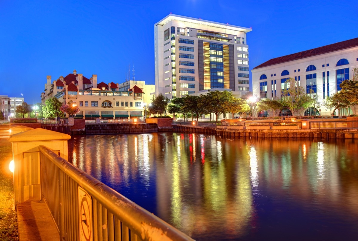 lake and building in downtown Stockton, California at dusk