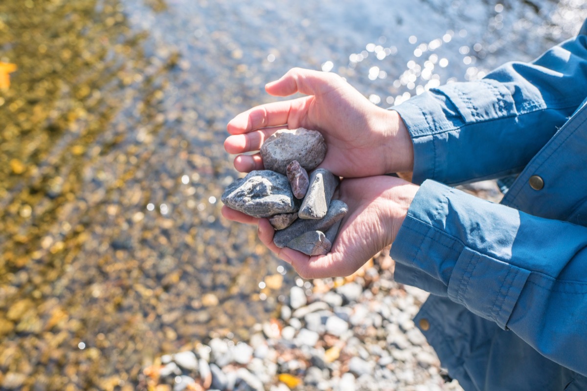 Woman holding stones.