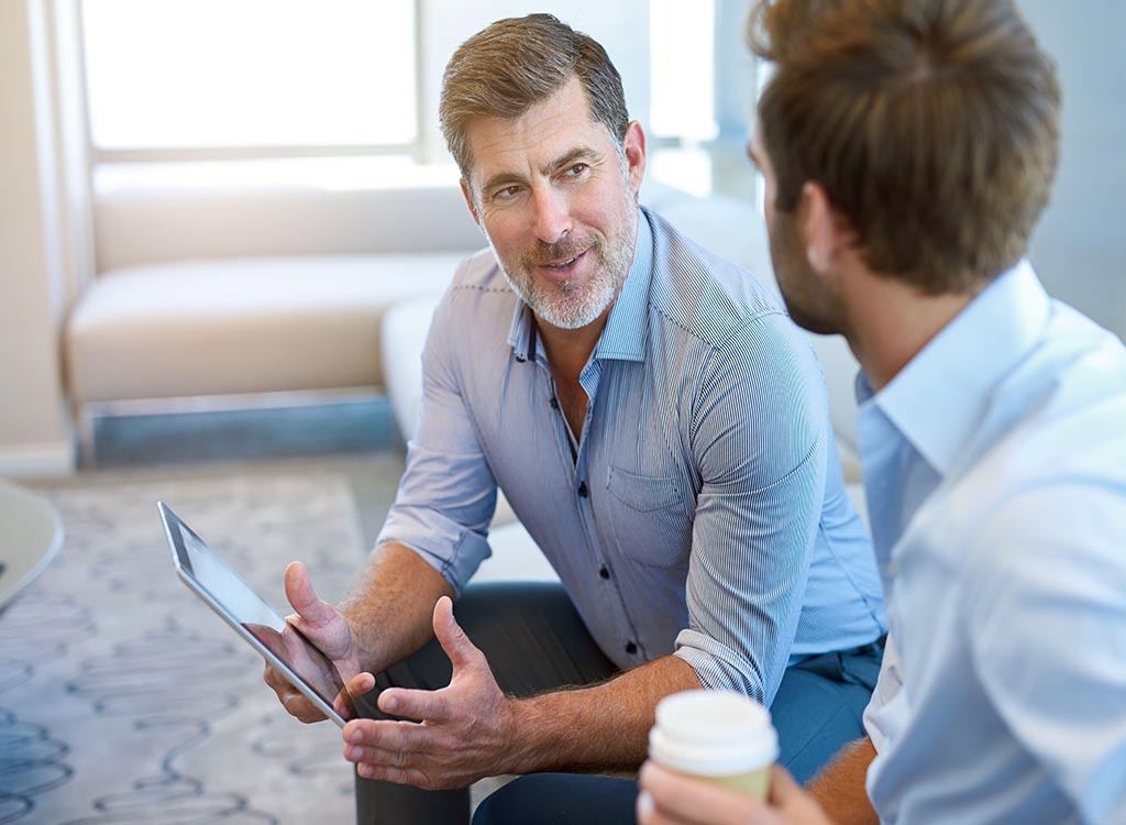  older businessman talking to his younger colleague, annoying things people do