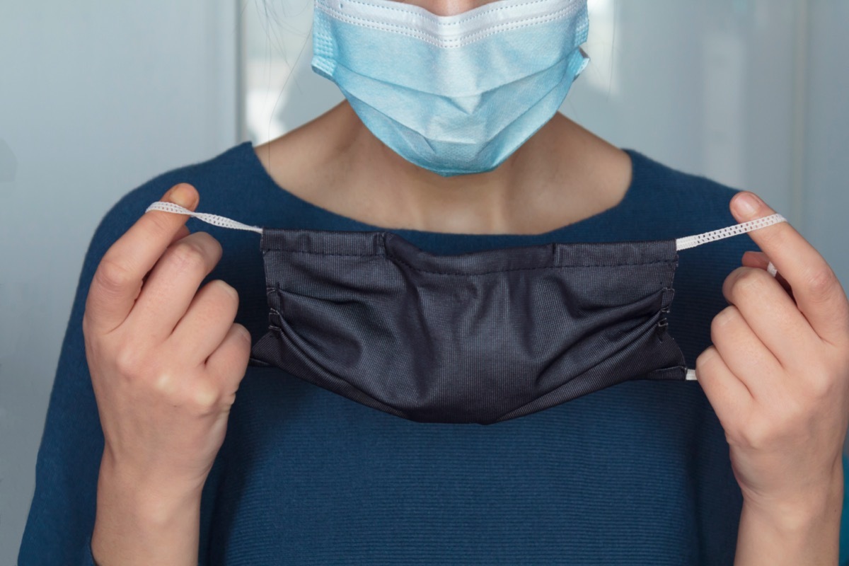 Woman putting a second face mask.