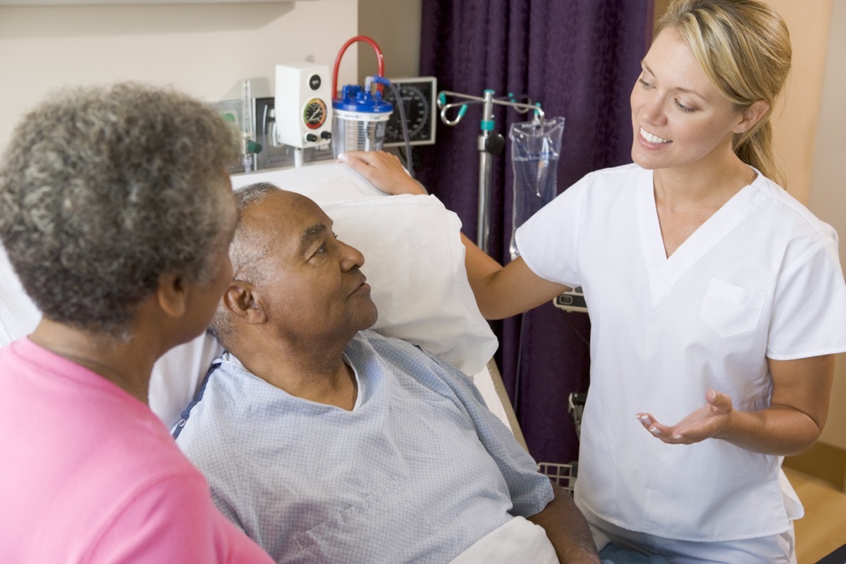 older man talking to specialist doctor, health questions over 50