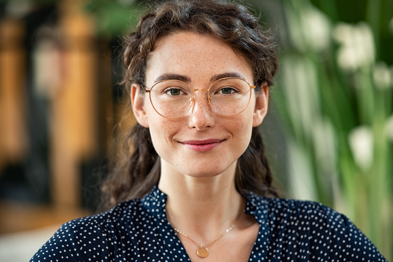 young woman in glasses smirking