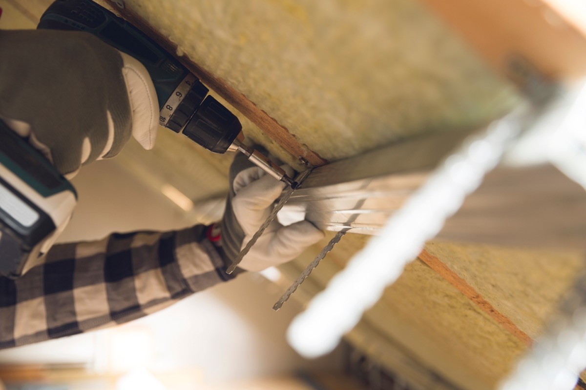 Man installing thermal roof insulation layer