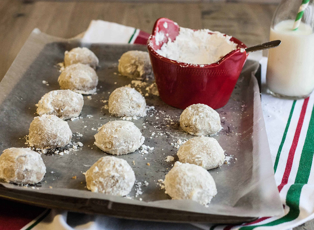 Toasted pecan cookies on a baking sheet with powdered sugar