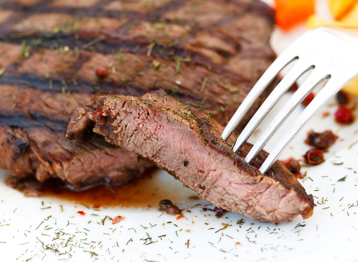 medium cooked steak fork white surface