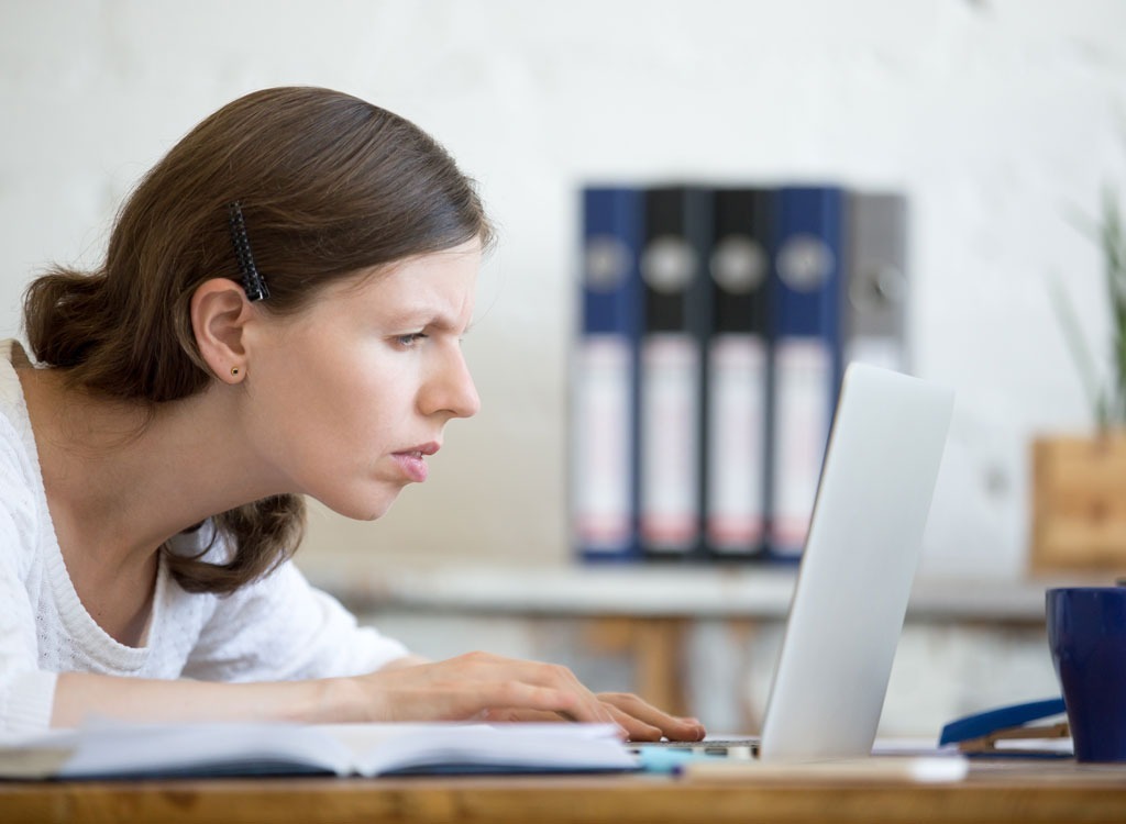 woman reading on laptop