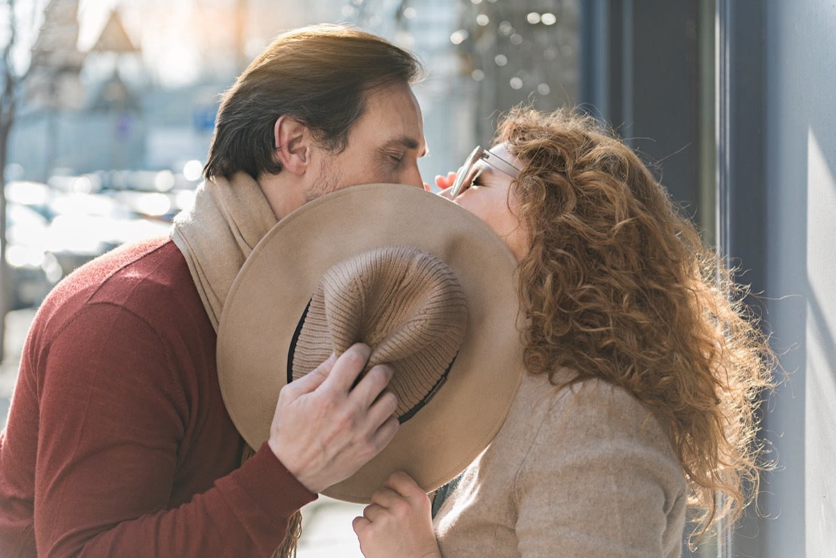 man and woman kissing in the street