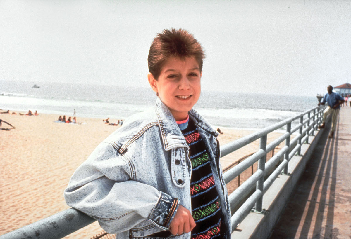 Ryan White photographed on a beach boardwalk