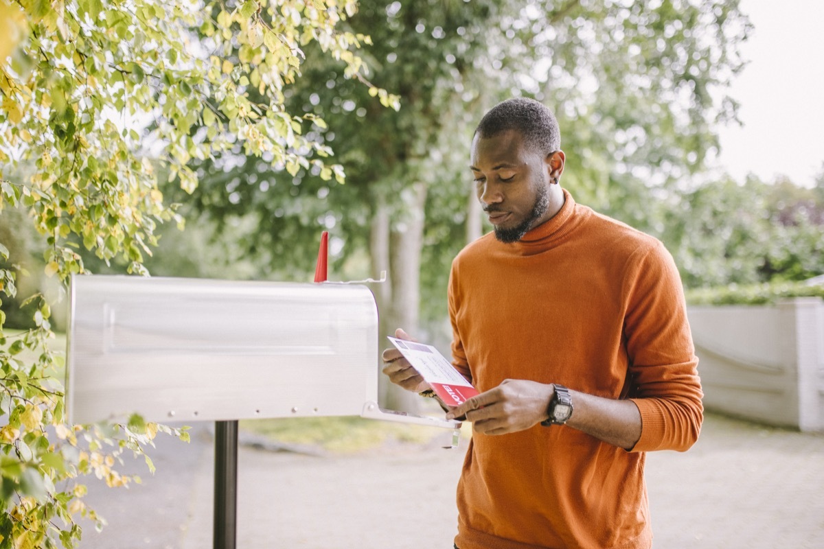 man receiving mail-in voting ballot.