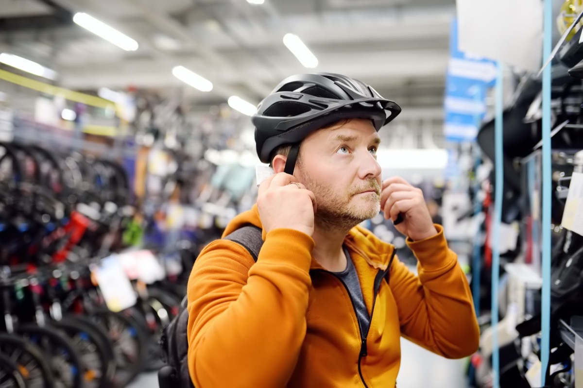 middle aged white man trying bike helmet