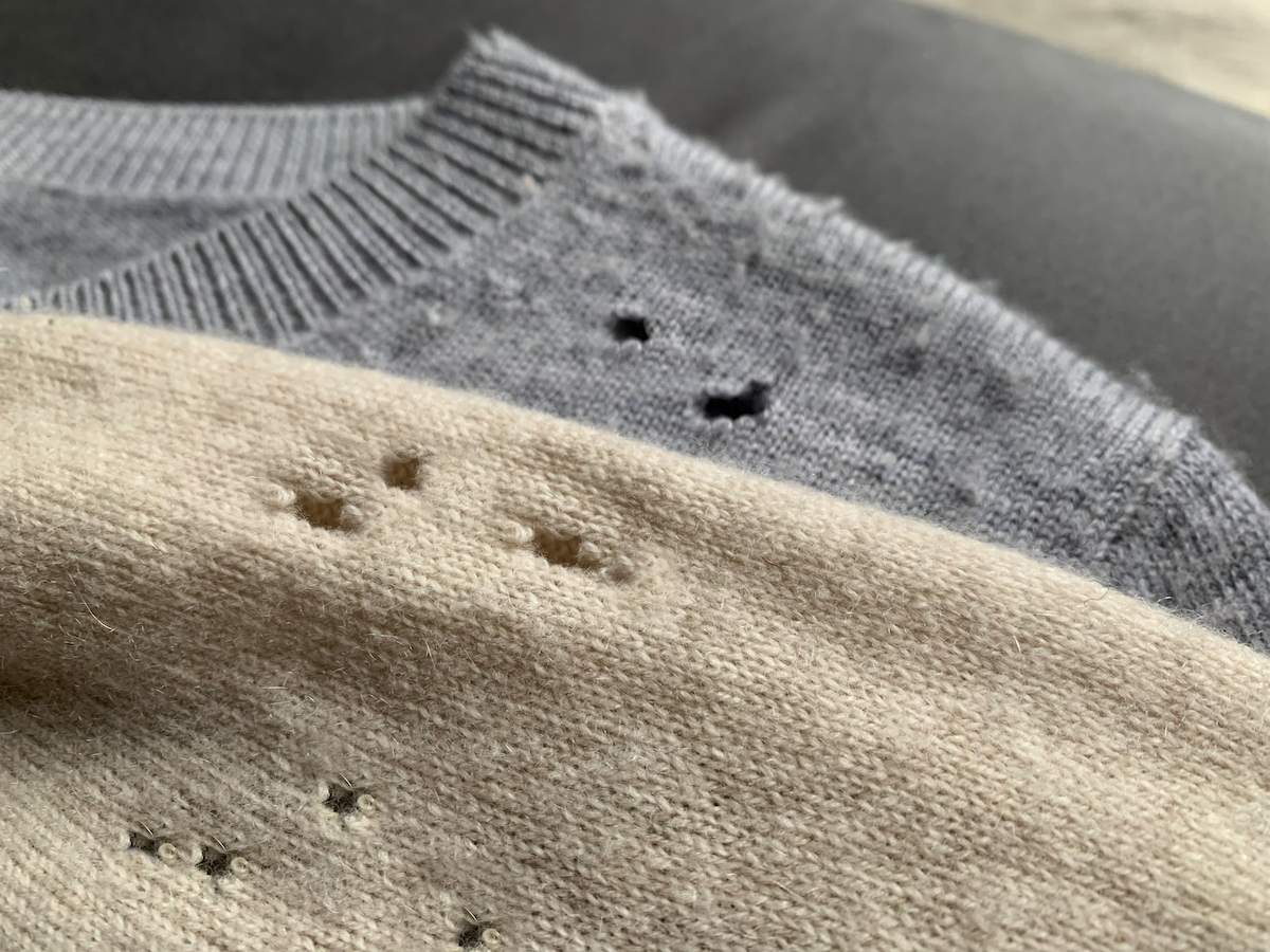 Two expensive cashmere sweaters with holes and damaged, caused by cloth moths